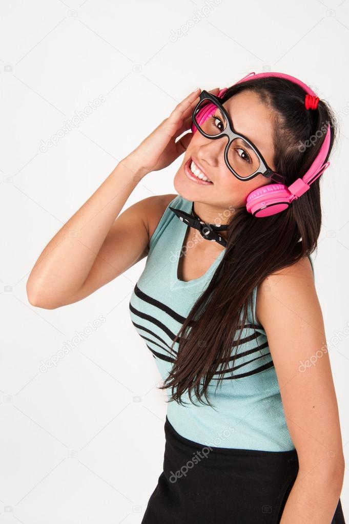 cute nerdy girl listening to music whilst looking at camera.