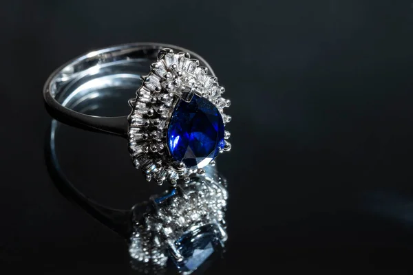 Κοσμήματα δαχτυλίδι με μεγάλο μπλε sapphir σε φόντο μαύρο άνθρακα — Φωτογραφία Αρχείου