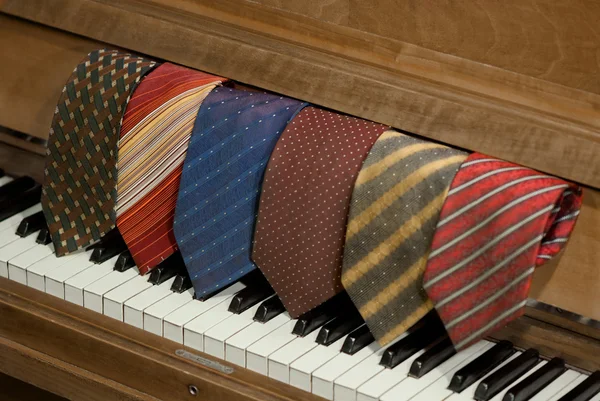 Neckties over a piano — Stock Photo, Image