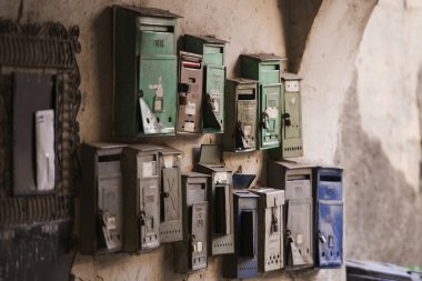 Few old mailboxes hanging on the wall in Romania clipart