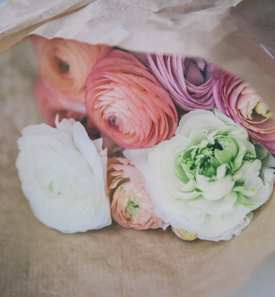 Ranunculus bouquet on craft paper
