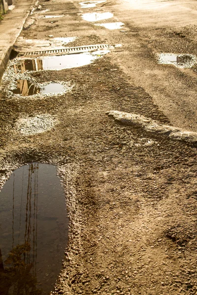 Broken road surface with water — Stock Photo, Image