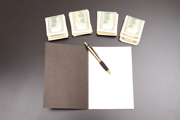 Dollars with a copybook — Stock Photo, Image