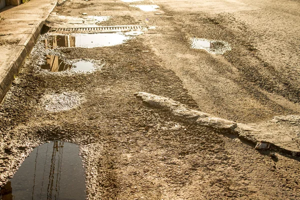 Broken road surface with water — Stock Photo, Image