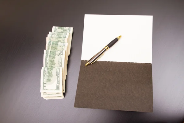 Dollars with a copybook — Stock Photo, Image