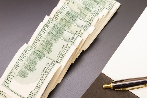 Dollars with a copybook — Stock Photo, Image