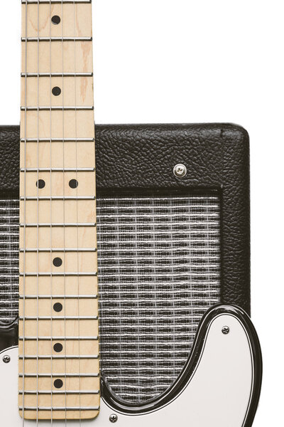 Maple fretboard from an electric guitar and a portion of a vintage amplifier, isolated on a white background