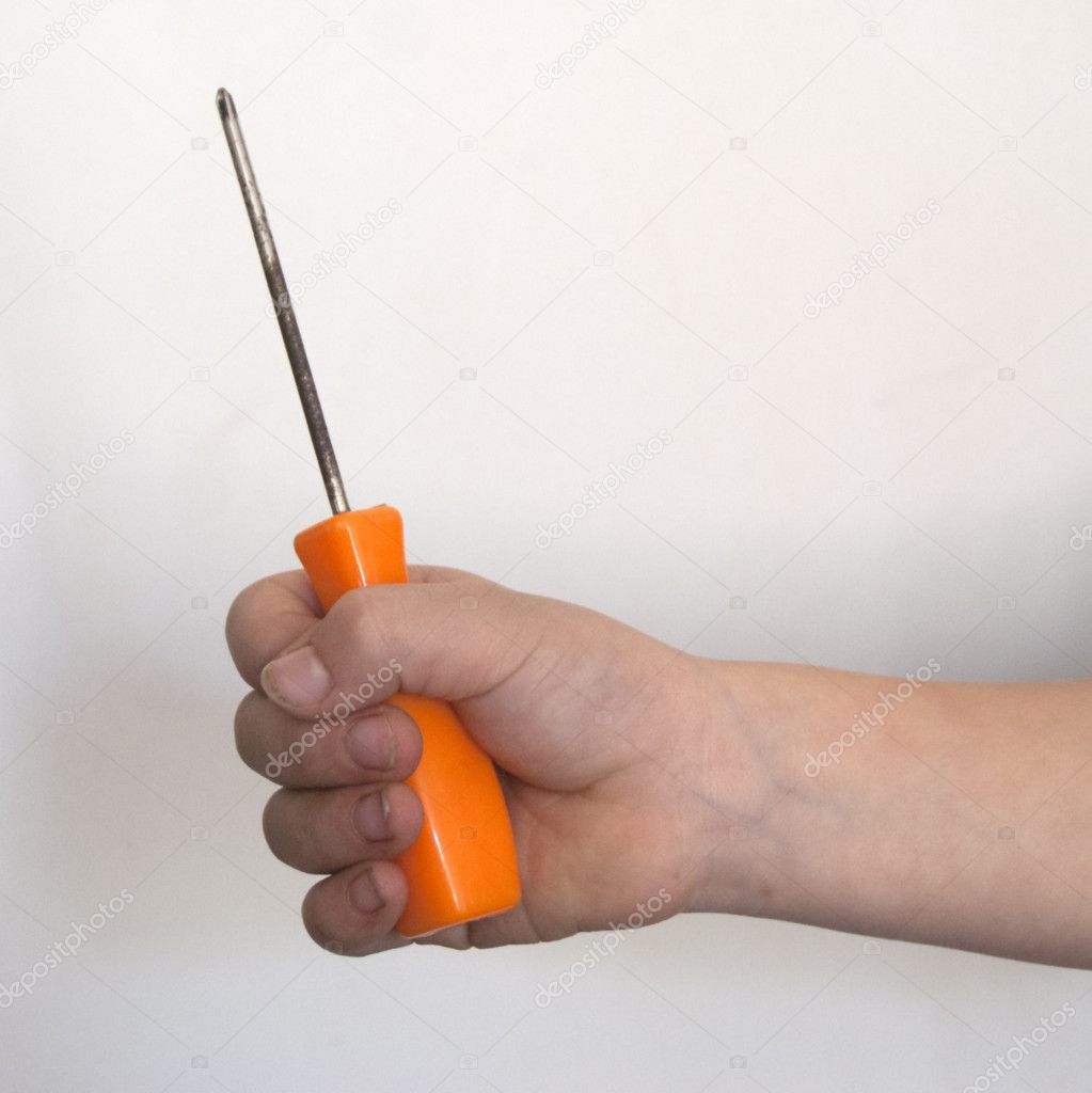 Kids hand holding screwdriver