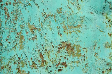 Arka plan paslı ve yeşil boyalı eski metalden oluşuyor.