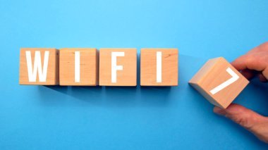 WiFi 7 sembolü. Kablosuz ağ 7 konsepti tahta küplerde. Mavi arkaplan, kopyalama alanı. İş, teknoloji ve WiFi 7 veya WiFi7 kavramı.