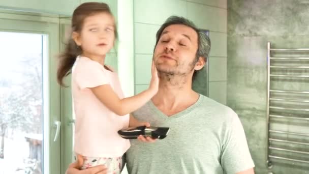 Putri dan ayah di kamar mandi sedang memotong rambut ayah melihat di cermin — Stok Video