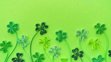 Shamrock leaves in quilling technique on a green background with copy space. St. Patrick's day sale promotion banner. St. Patrick's Day background with clover and trefoil. Good luck concept banner. clipart