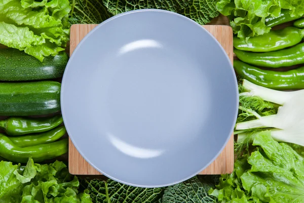 Vegetables and plate — Stock Photo, Image