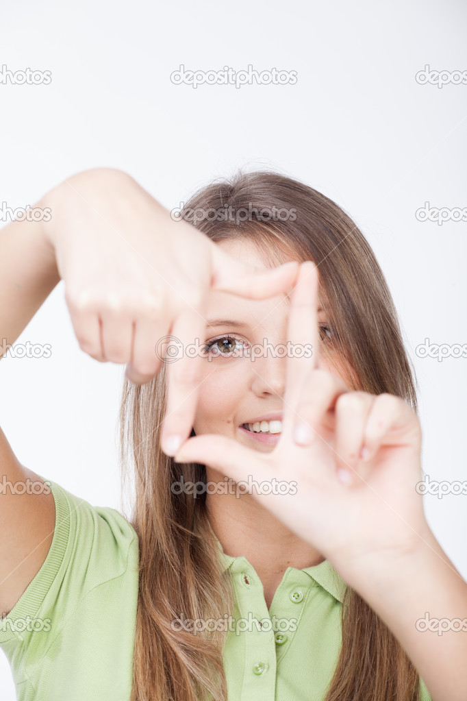 Young attractive woman framing her hands