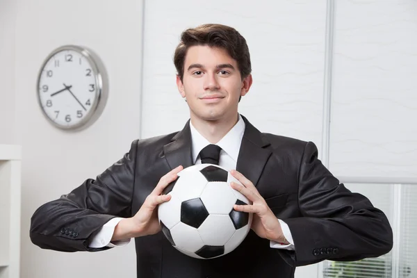 Businessman holding a soccer ball — Stock Photo, Image