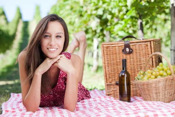 Happy young woman having a picnic — Stock Photo, Image
