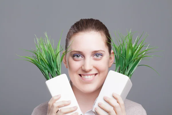 Closeup of a teenager hiding behind some grass — Stock Photo, Image