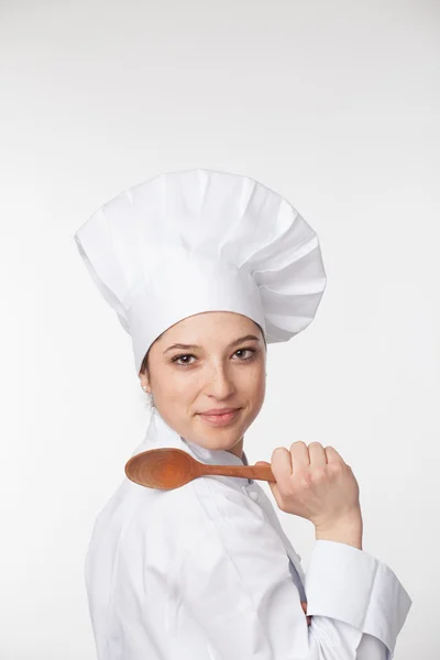 Une jeune cuisinière dans un chapeau et un manteau traditionnels .. — Photo