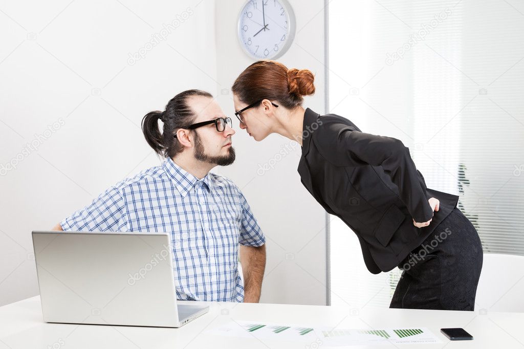 Angry businesswoman is slapping across the businessman's face