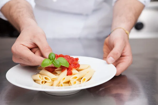 Chef Adding Fresh Basil to Plate of Pasta — Stock Photo, Image