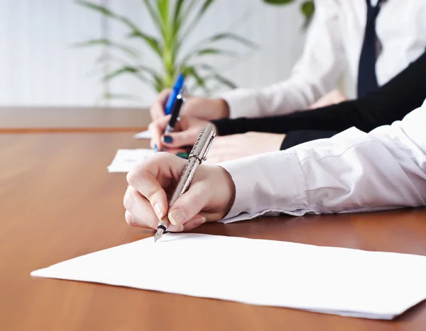 Person's hand signing an important document — Stock Photo, Image