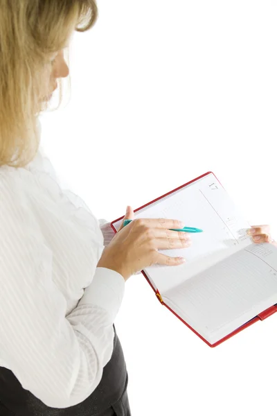 Close up of female hand making notes in calendar — Stock Photo, Image