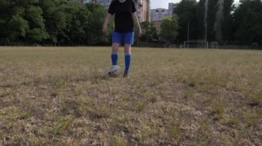 girl soccer player dribbles the ball across the field
