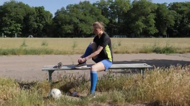 Soccer Player Girl Tying Shoelaces Preparing Training Sitting Old Bench — Video