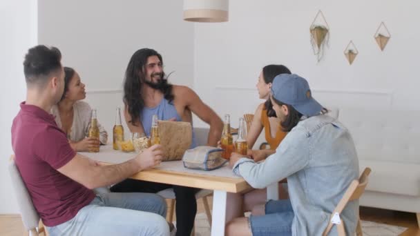 Group Friends Sitting Table Talking Suddenly One Guys Exclaims Sharply — Stock videók