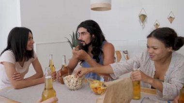 man telling a story to his friends at the table