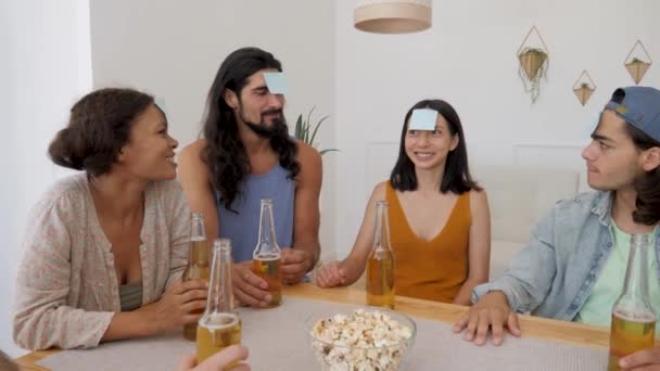 Company Plays Game Who Leaves Glued Forehead Girl Guesses Who – Stock-video