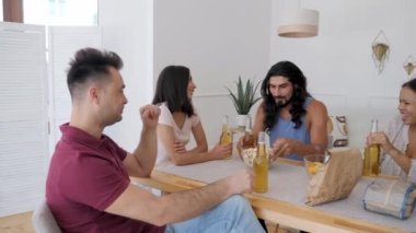 a group of friends chatting while sitting at a table