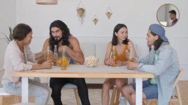 Bir grup arkadaş bir masada oturup bira içerken, bir adam gelip şişeleri kontrol ettiğinde, neden bira köpükleri ve şişeden dökülüyor?