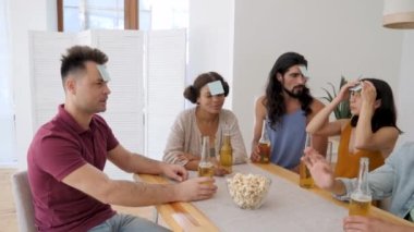 the company is playing leaflets on their foreheads in a game called who am I