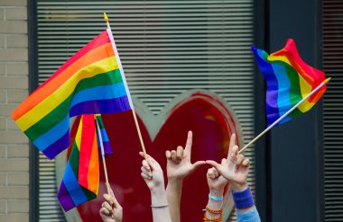 Hands waving gay flags clipart