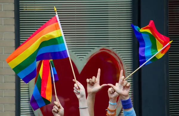 Hands waving gay flags — Stock Photo, Image