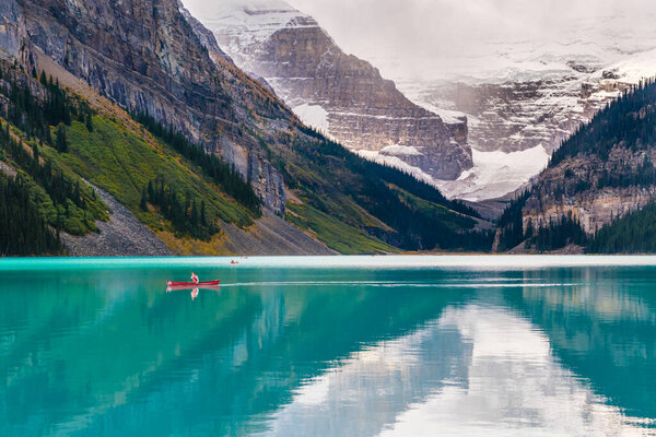 Lake Louise, Alberta, Canada - 29 September 2021: Man riding a Canoe on iconic turquoise Lake Louise in the Canadian Rockies.
