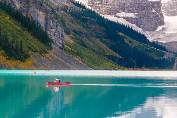 Lake Louise, Alberta, Canada - 29 September 2021: Man riding a Canoe on iconic turquoise Lake Louise in the Canadian Rockies.