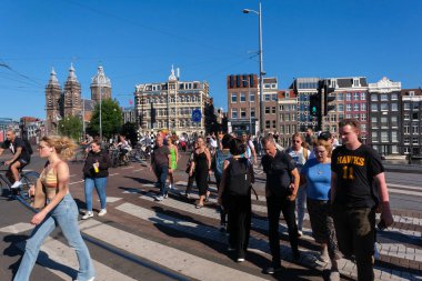 Amsterdam, Hollanda - 22 Haziran 2022: Amsterdam 'da birçok kişi karşıdan karşıya geçiyor