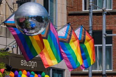 Montreal, CA - 5 August 2022: Disco ball and LGBTQ Progress Pride Flags during Pride week Fierte Montreal