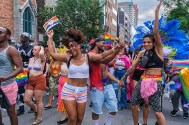 Montreal, CA - 7 August 2022: Young people dancing during the spontaneous gay pride march after official pride parade was cancelled