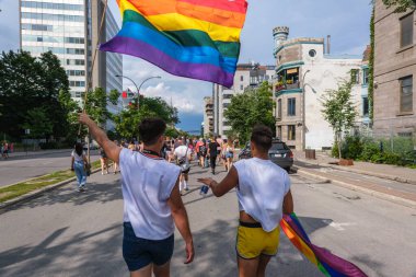 Montreal, CA - 7 August 2022: Two young men take part in spontaneous gay pride march after official pride parade was cancelled