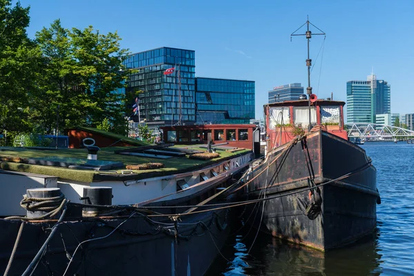 Amsterdam, Netherlands - 22 June 2022: Old Houseboat moored on the North Sea Canal
