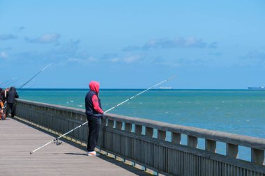Calais, France - 26 June 2022: Fishermen on Calais Jetty