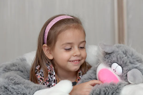 Girl with cat soft toy — Stock Photo, Image