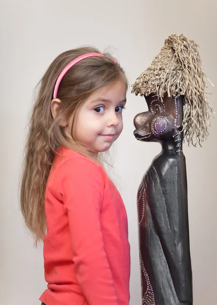 Little girl with ethnic doll — Stock Photo, Image