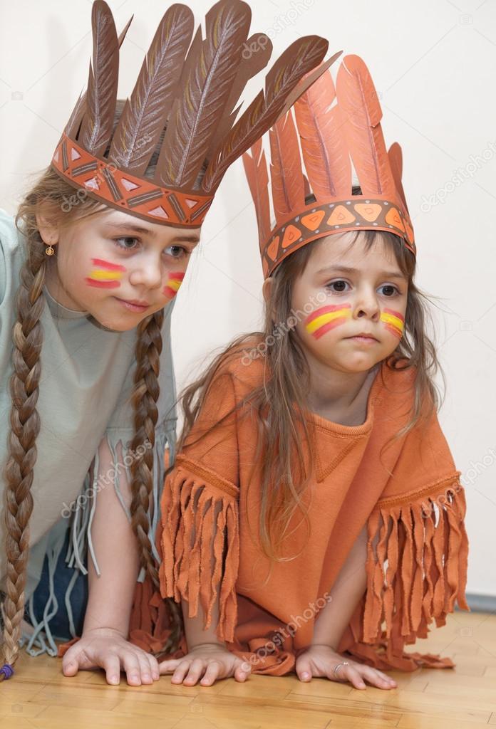 Two little girls playing Indians