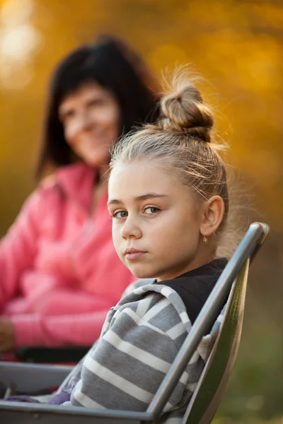 Pretty young girl and mom in background — Stock Photo, Image