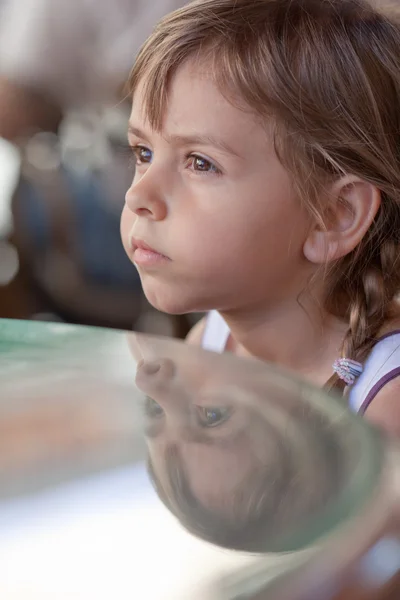 Portrait of little girl with her reflection — Stock Photo, Image