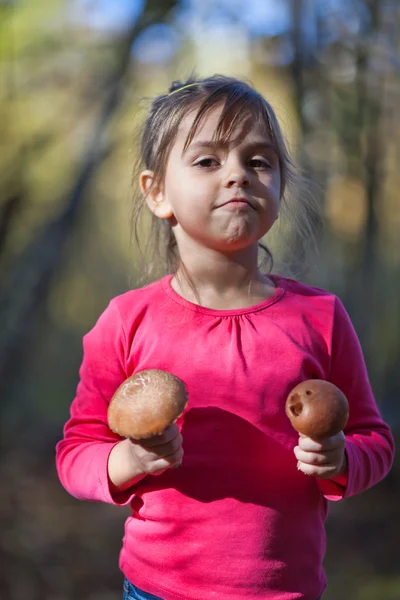 Little girl with mushrooms — Stock Photo, Image